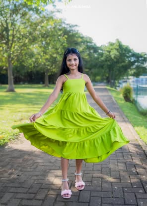 Birthday photoshoot of a girl twirling a green dress beside a lake in Colombo, Sri Lanka