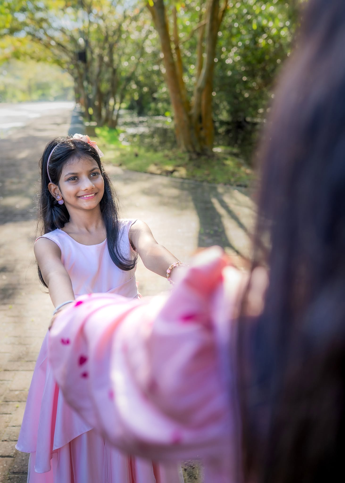 Birthday photoshoot of a girl in a pink dress on a tree-lined path, Colombo, Sri Lanka