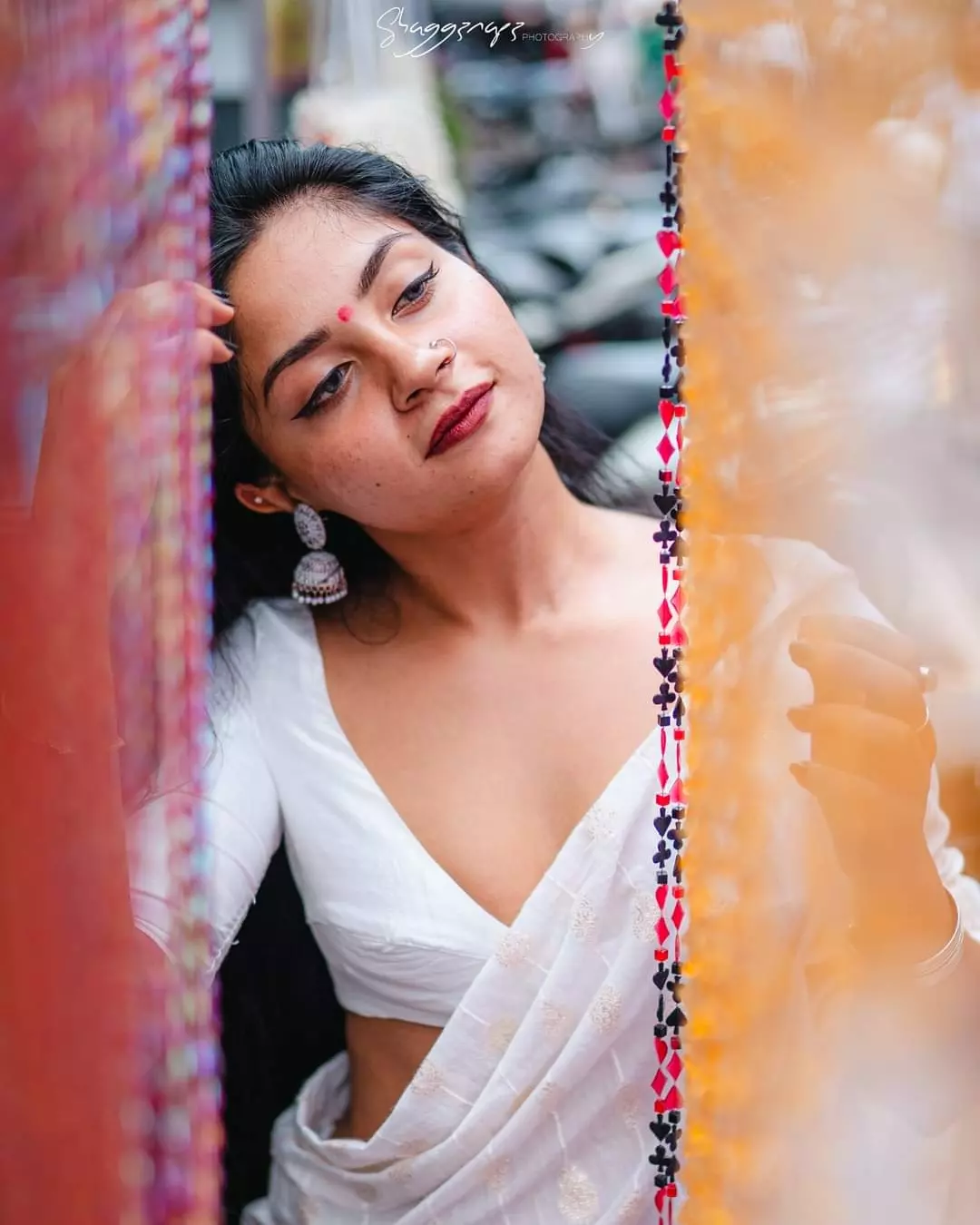 Desi fashion portrait photoshoot peeking through a bead curtain, Colombo, Sri Lanka