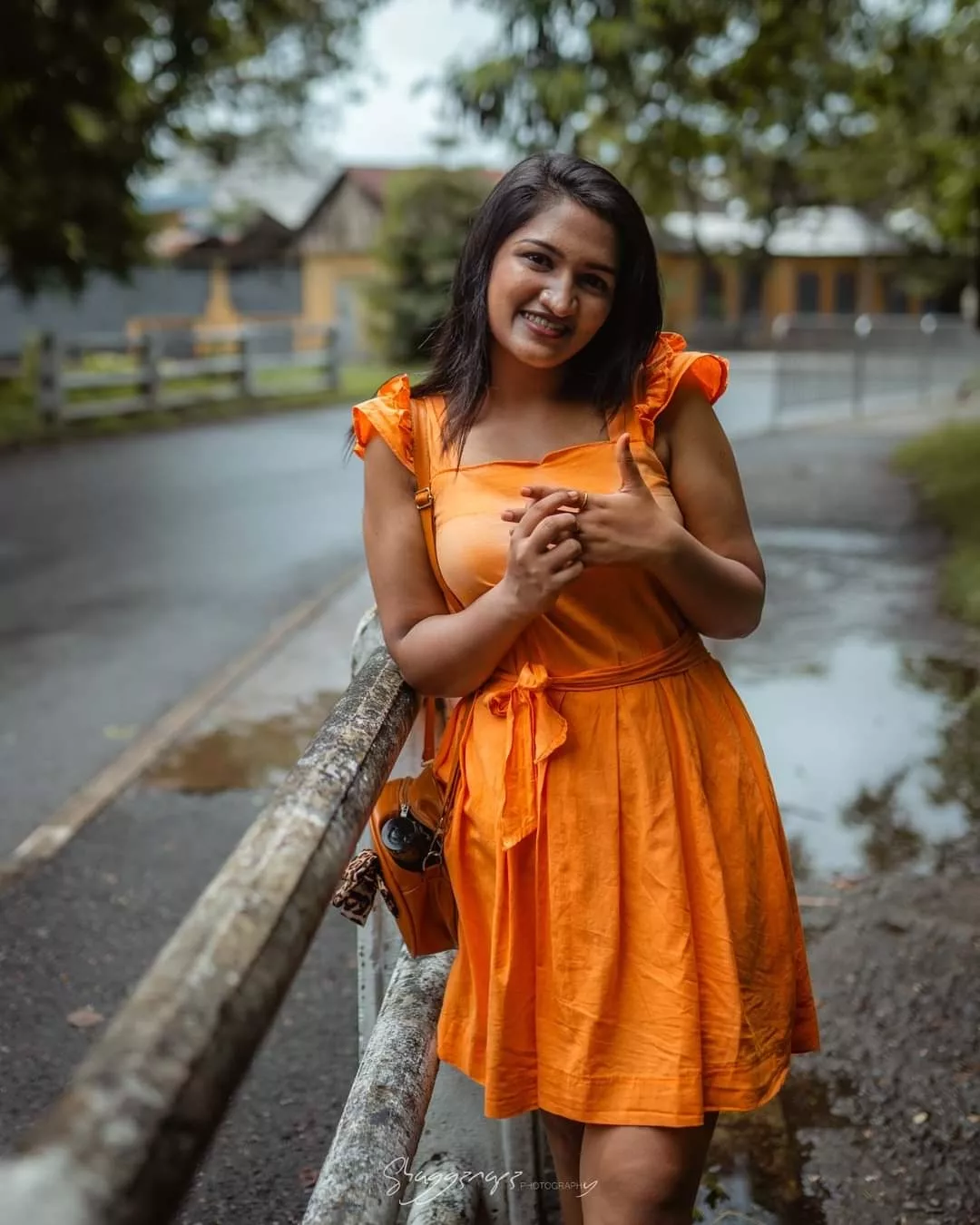 Orange dress fashion editorial photoshoot on a bridge in Colombo, Sri Lanka