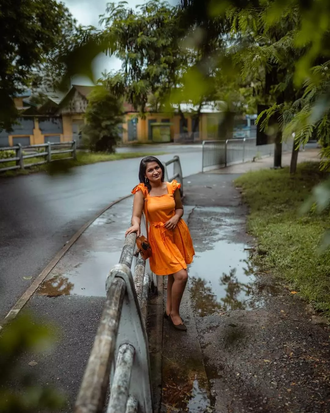 Orange dress fashion editorial portrait on a bridge in Colombo, Sri Lanka
