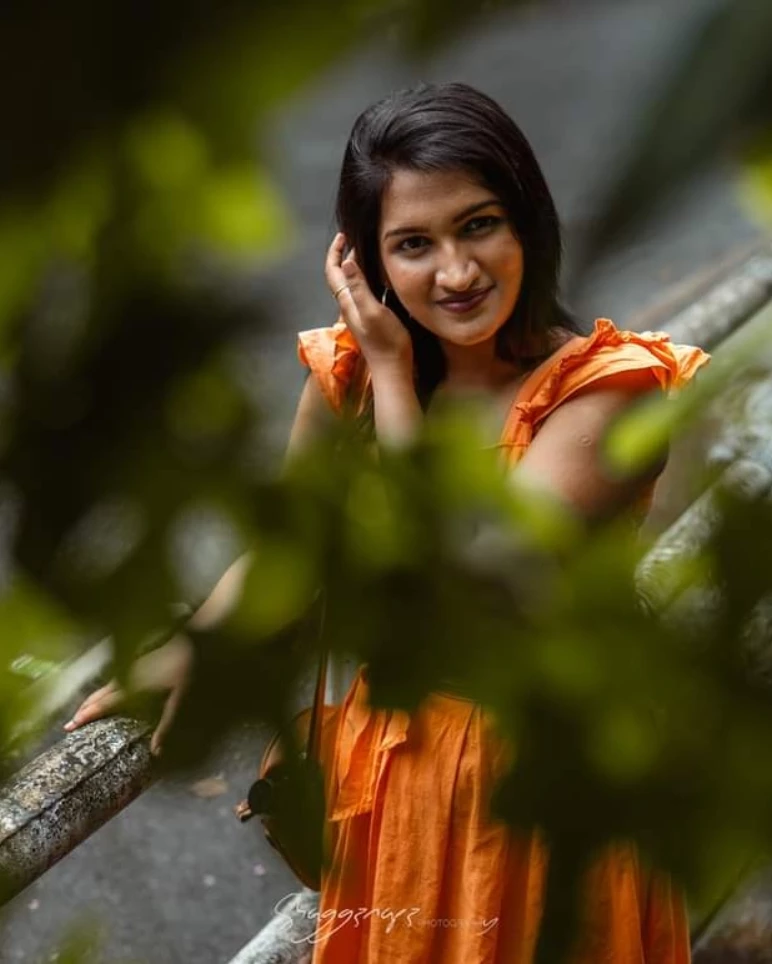 Fashion editorial portrait through foliage in Colombo, Sri Lanka