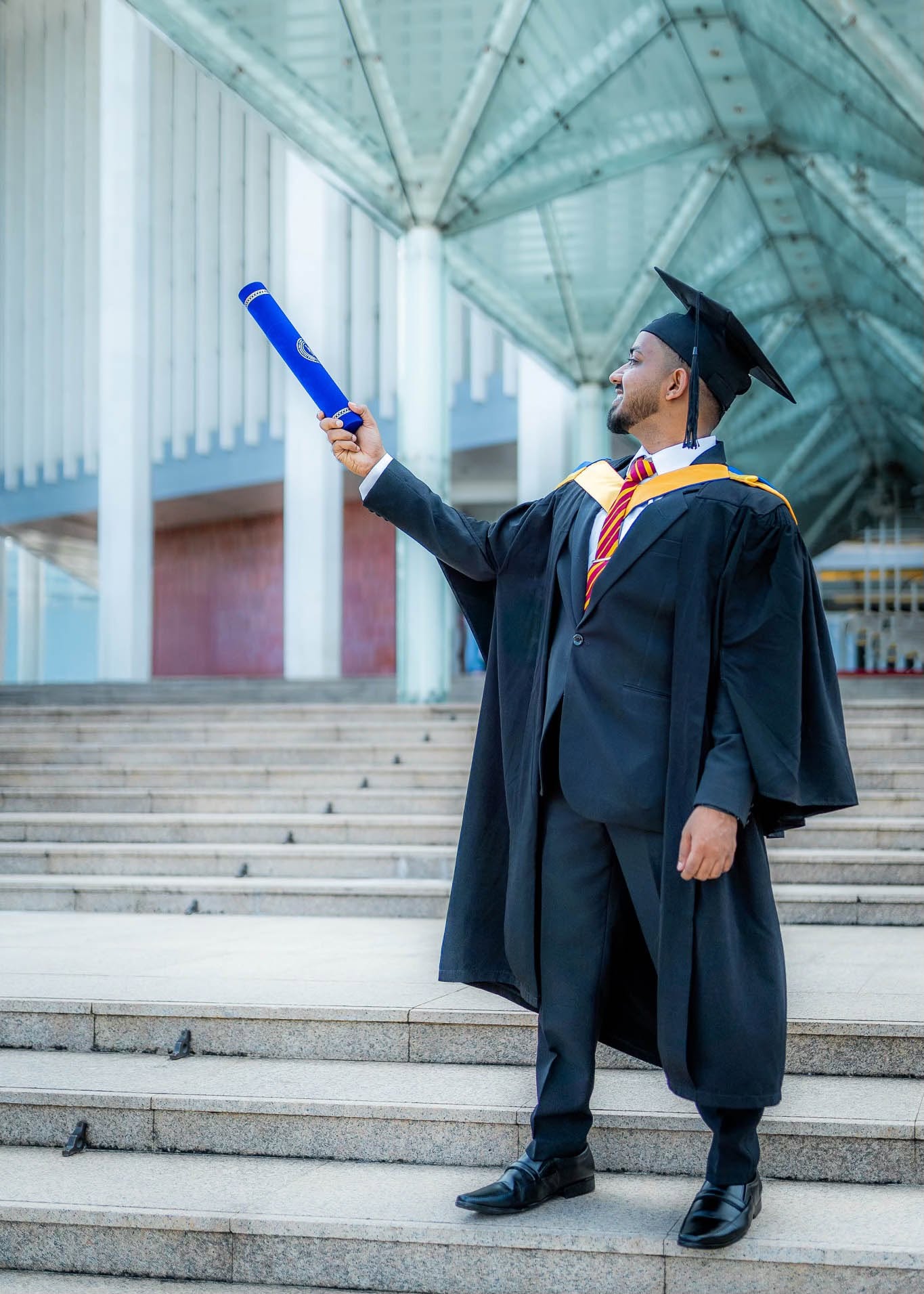 Graduation portrait photography holding a diploma scroll in Colombo, Sri Lanka