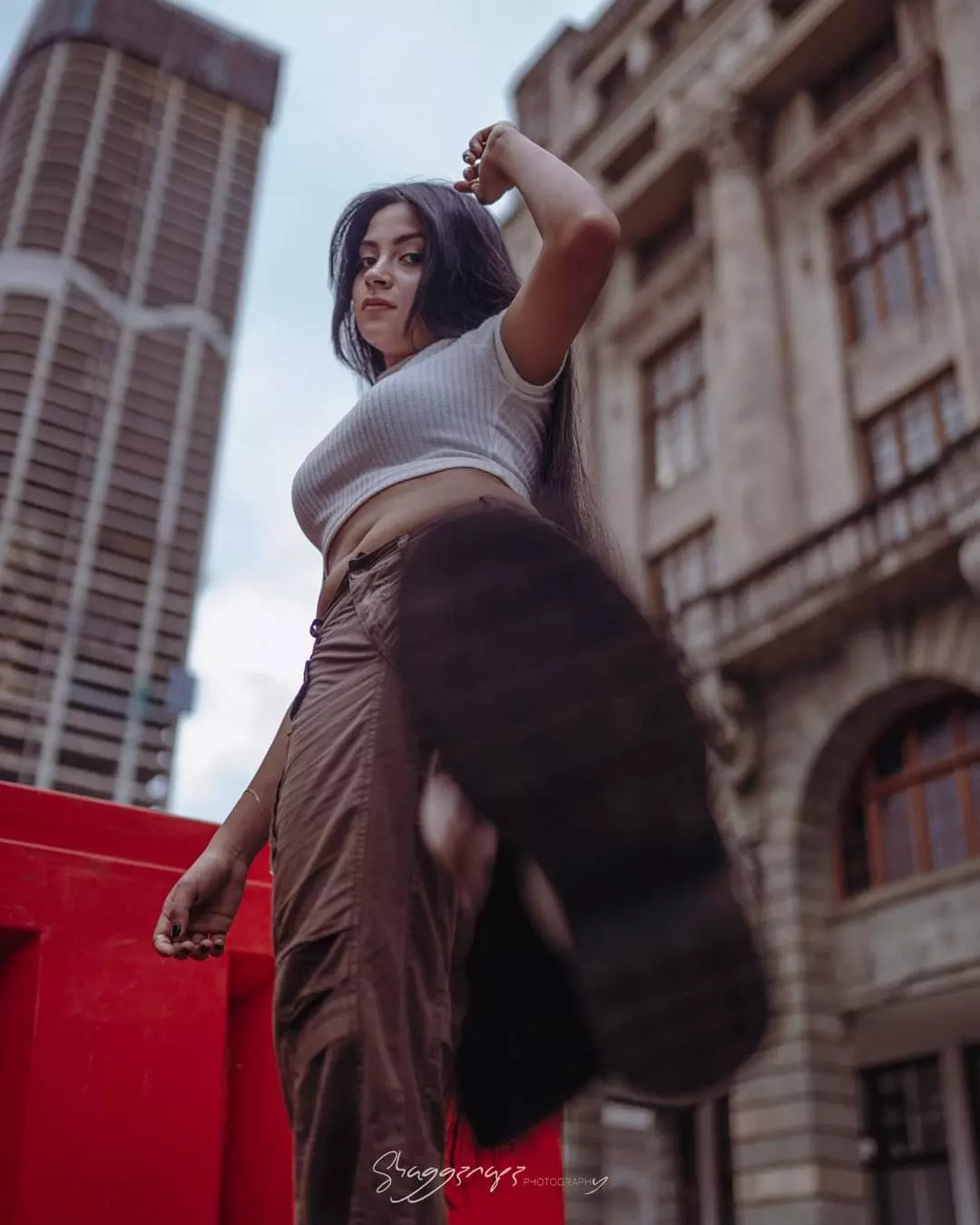 Low-angle street fashion photography against city skyscrapers in Colombo, Sri Lanka